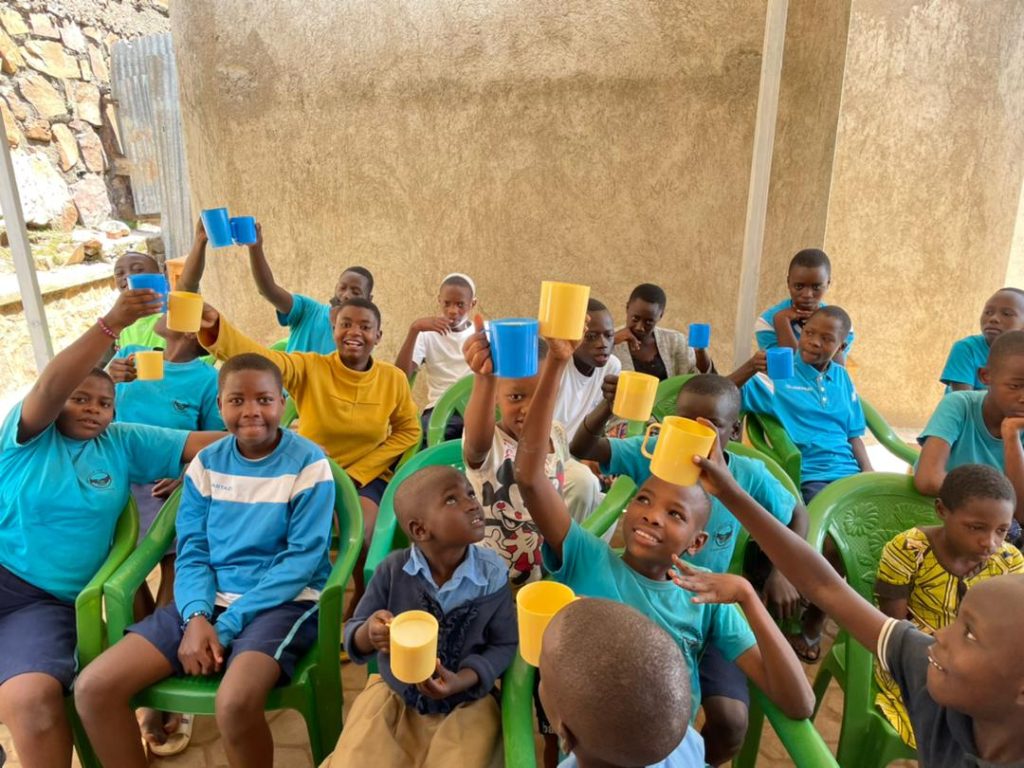 Happy children raising cups